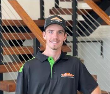 Man standing in front of SERVPRO sign
