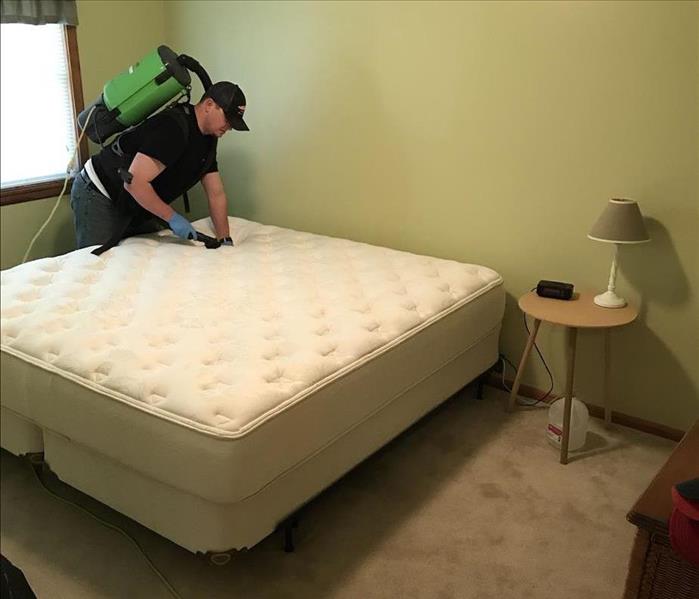 Vacuuming a mattress  