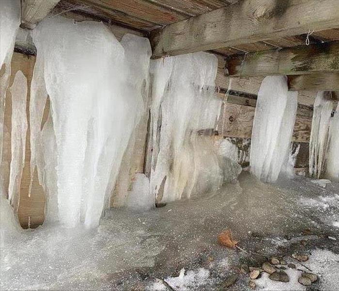 Large icicles trapped underneath a crawl space.  