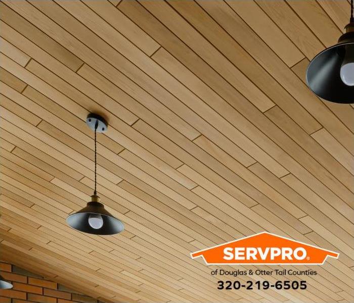 Clean, modern lighting and a custom wood ceiling are shown.